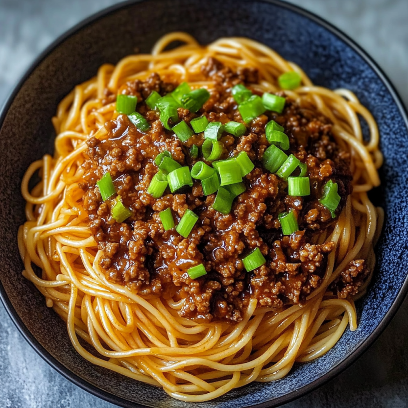 A bowl of Asian ground beef noodles.