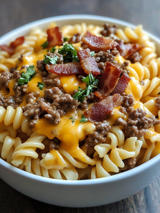 A bowl of pasta with bacon and cheese.