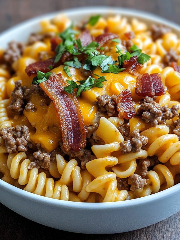 A bowl of pasta with bacon and cheese.