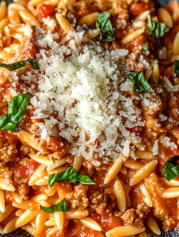 A bowl of ground turkey orzo in tomato sauce.
